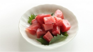 Yellowfin Tuna Poke Cubes Thunnus albacares in a bowl with shiso leaves
