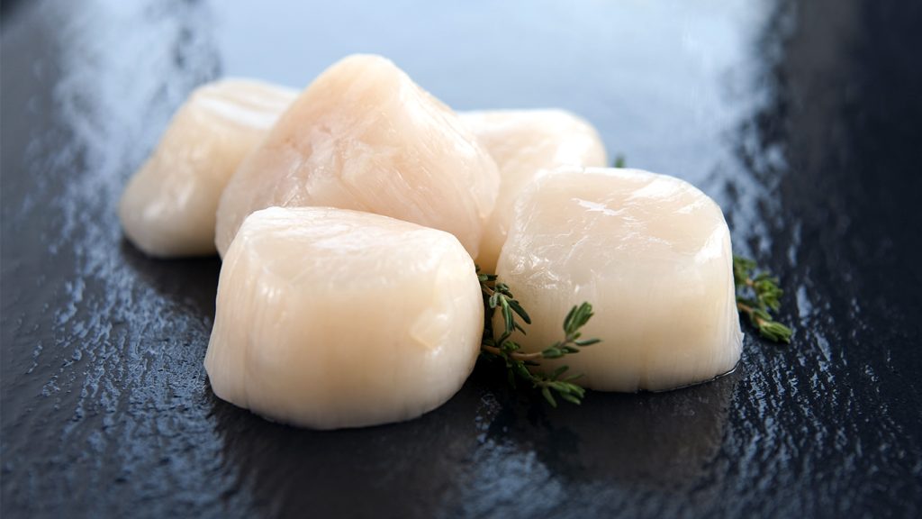 scallop meat on black slate