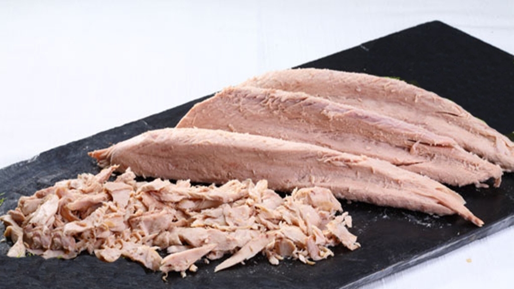 precooked tuna loins and flakes on black slate